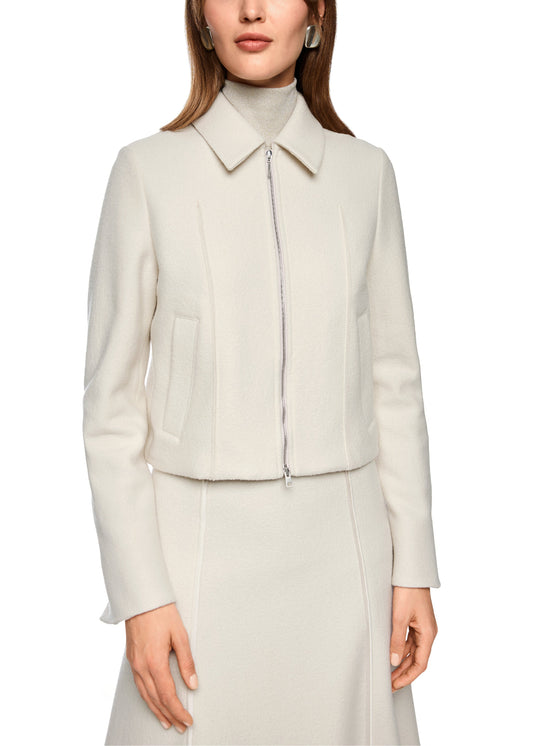 Woman wearing a light gray suit on a white background