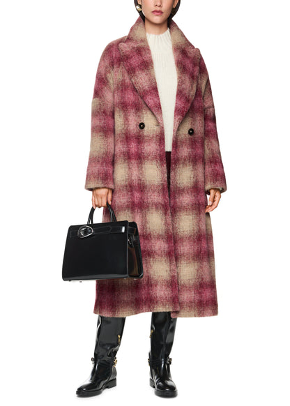 Person wearing a plaid coat holding a black handbag on a white background