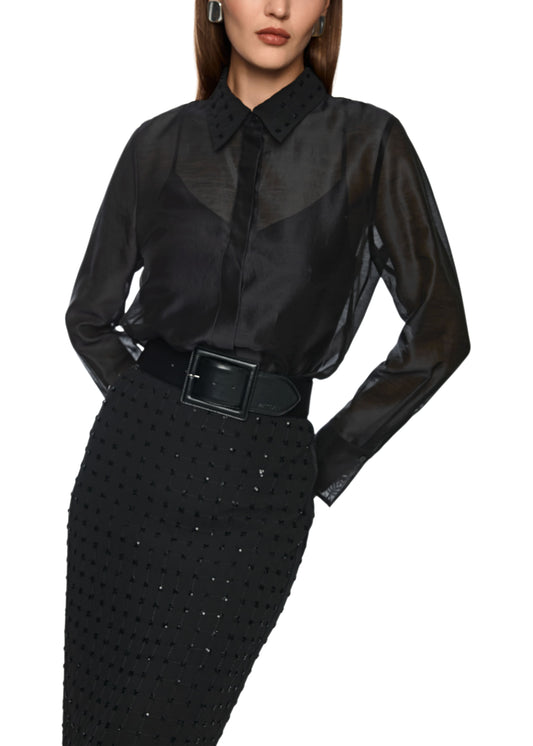 Black sheer blouse with a belt and black skirt on a white background