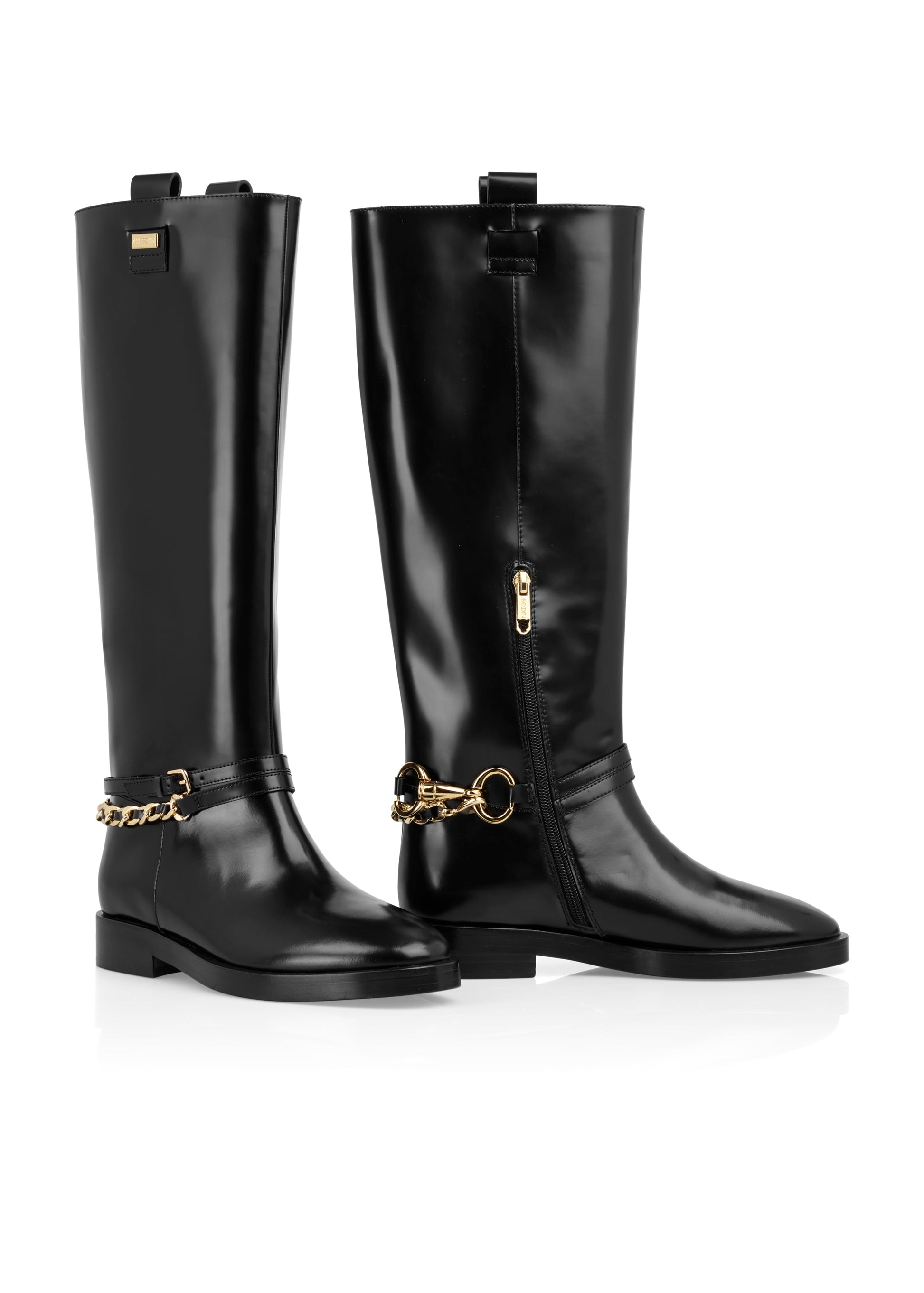 Pair of black knee-high boots with gold chain details on a white background