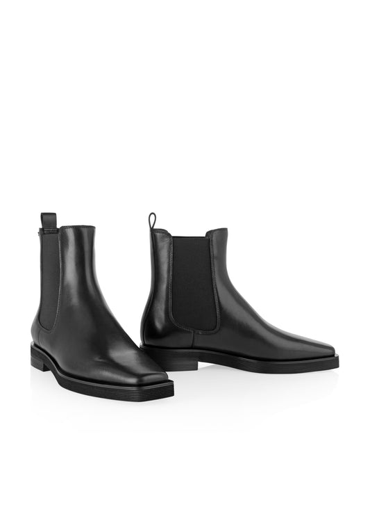 Pair of black leather Chelsea boots on a white background