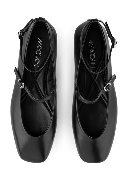 Black ballet shoes with 'Marc Cain' branding on a white background