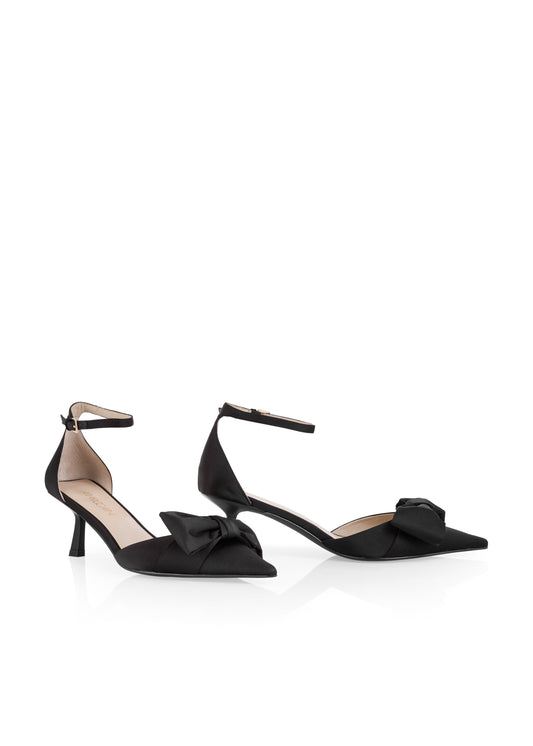 Black high-heeled shoes with bow details on a white background