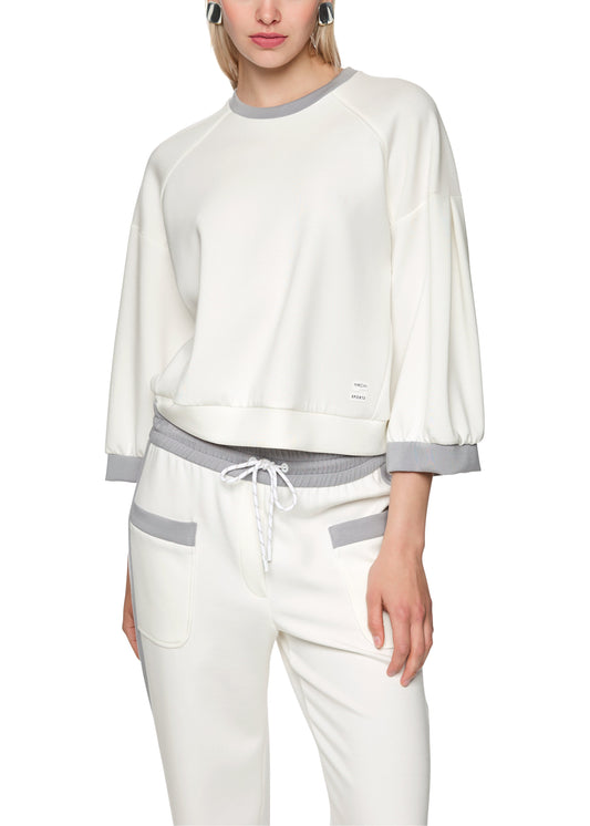 Woman wearing a white and gray outfit on a white background