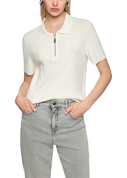 Person wearing a white short-sleeve top with a zipper and gray jeans on a white background