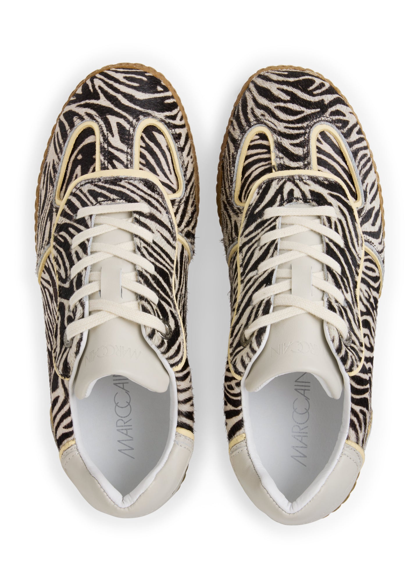 Pair of zebra-patterned sneakers on a white background