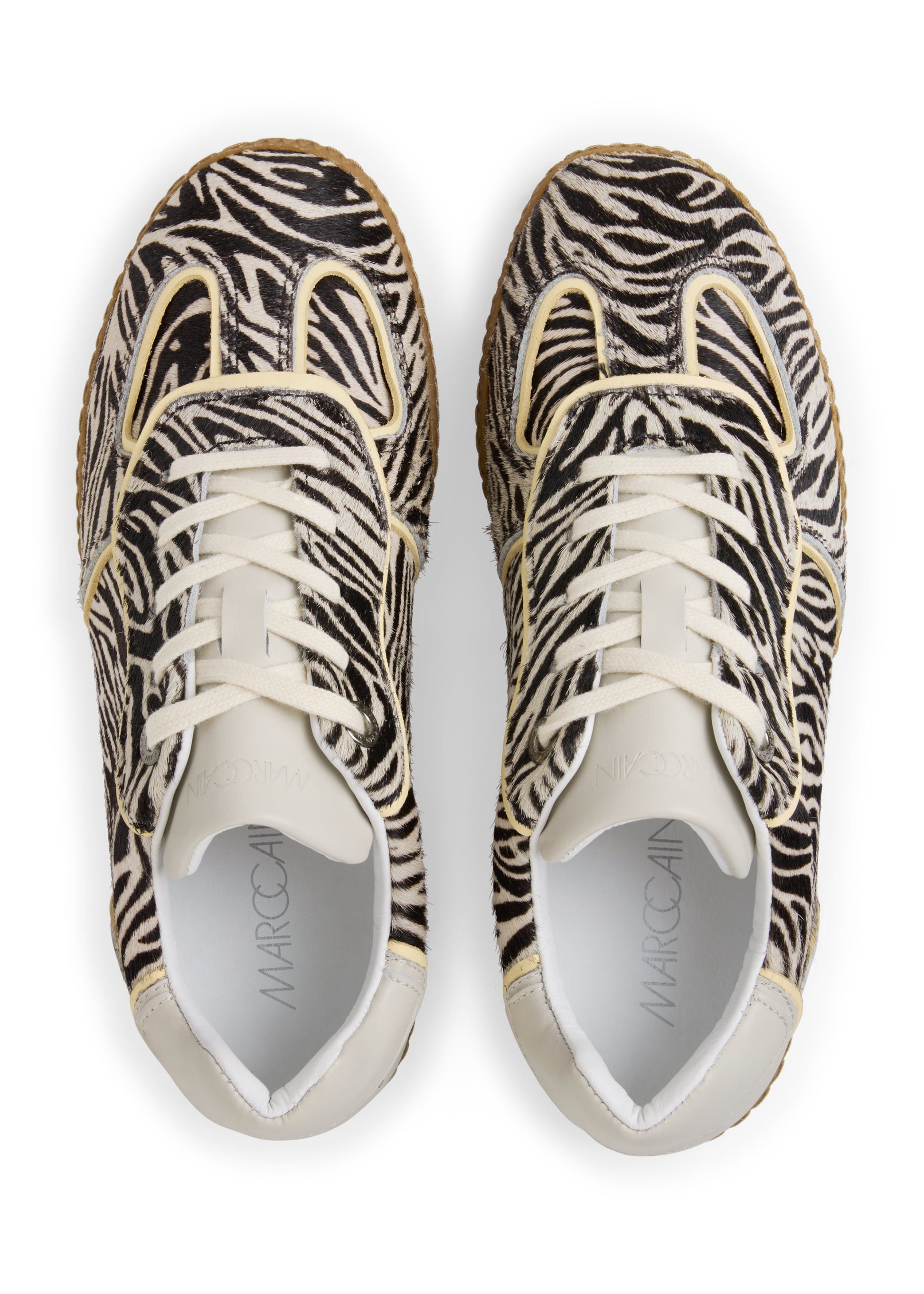Pair of zebra-patterned sneakers on a white background