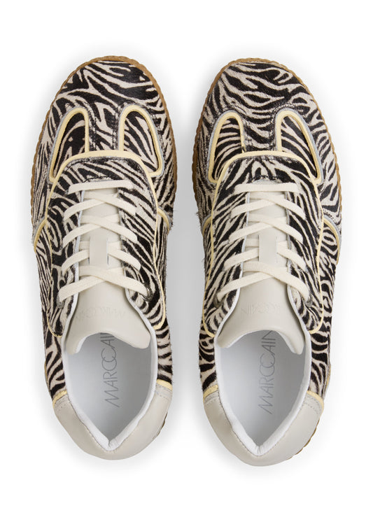 Pair of zebra-patterned sneakers on a white background