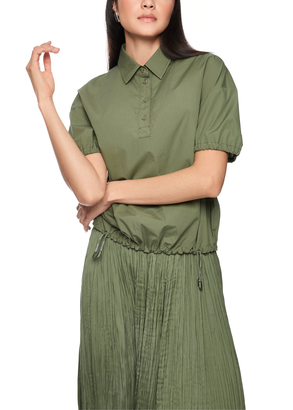 Woman wearing a green dress with a white background