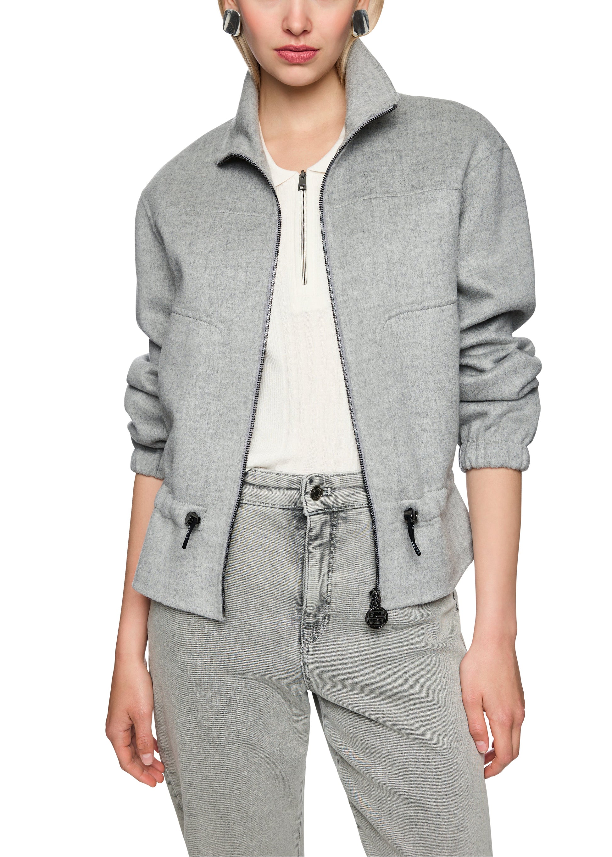 Person wearing a gray jacket and pants on a white background