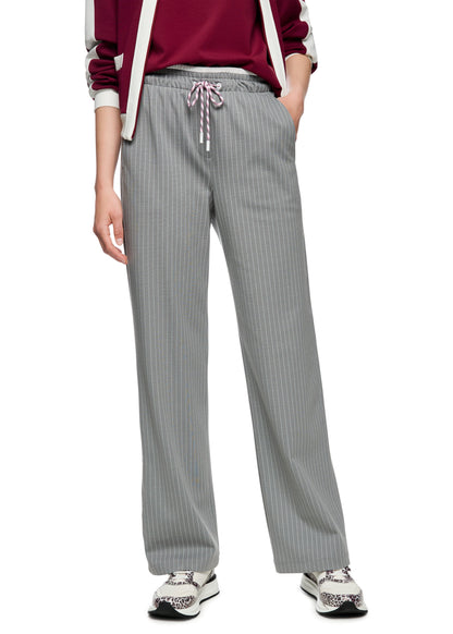 Person wearing gray pinstripe pants with a white background