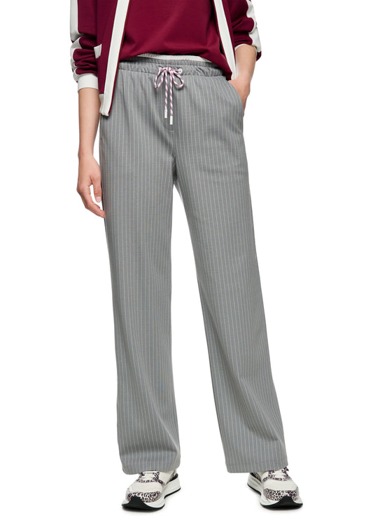 Person wearing gray pinstripe pants with a white background