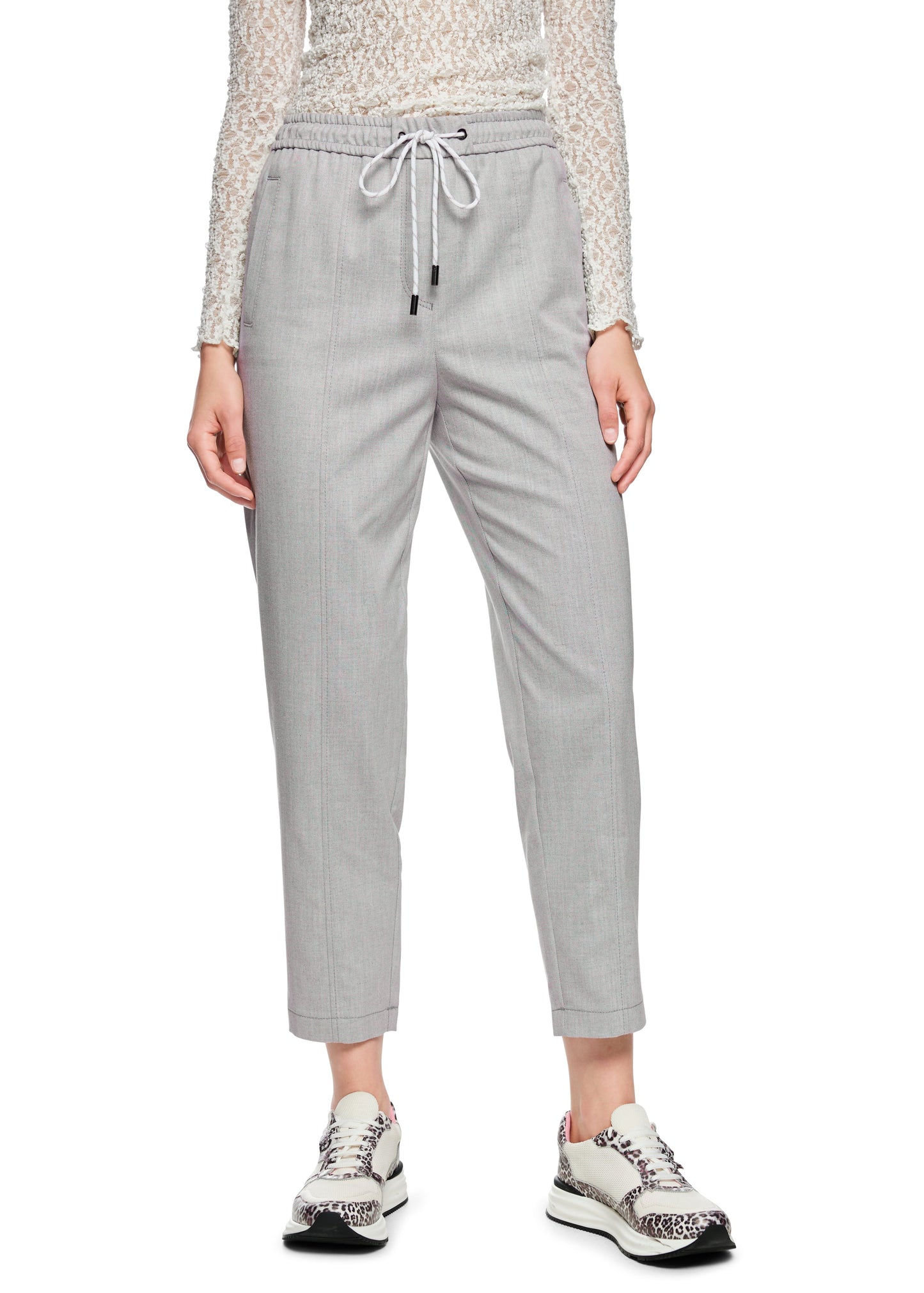 Light gray pants worn by a person on a white background