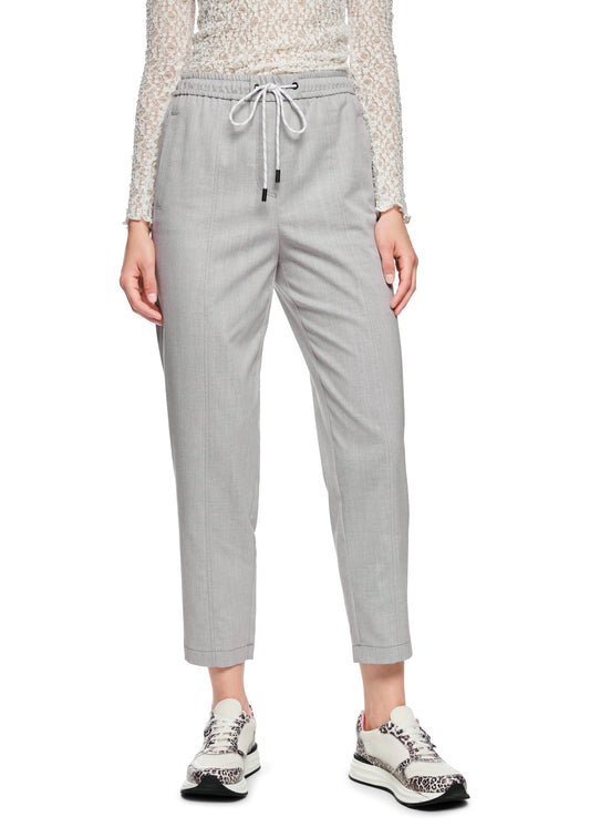Light gray pants worn by a person on a white background