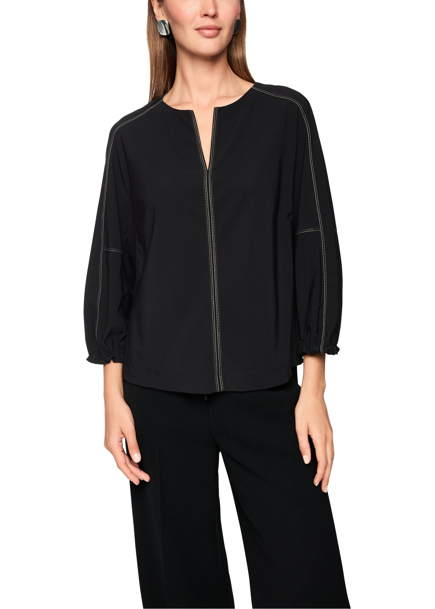 Black blouse with a zipper on a white background