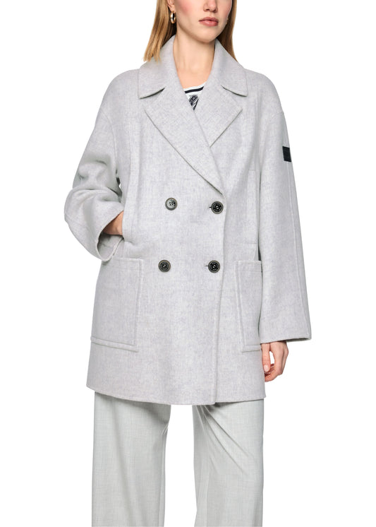 Person wearing a gray coat with a white background