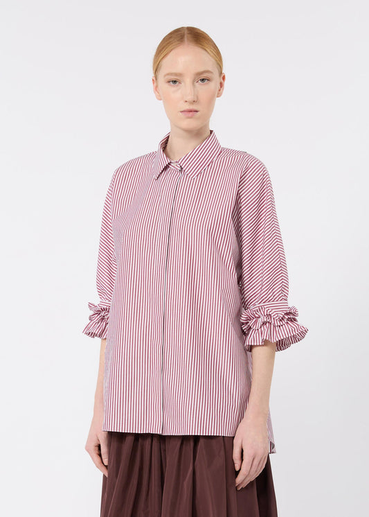 Woman wearing a pink and white striped shirt on a white background