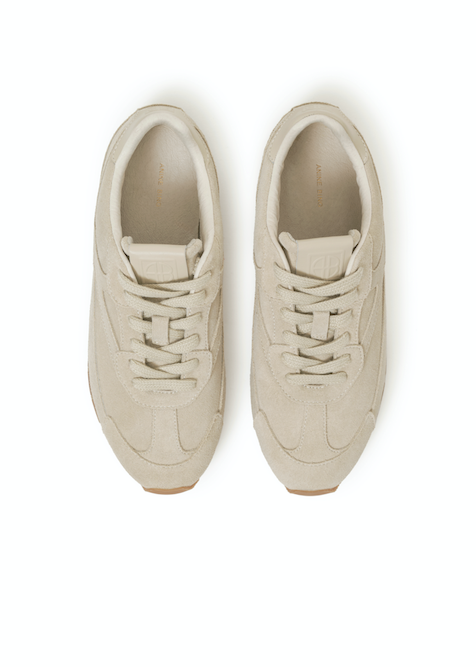 Pair of beige sneakers on a white background