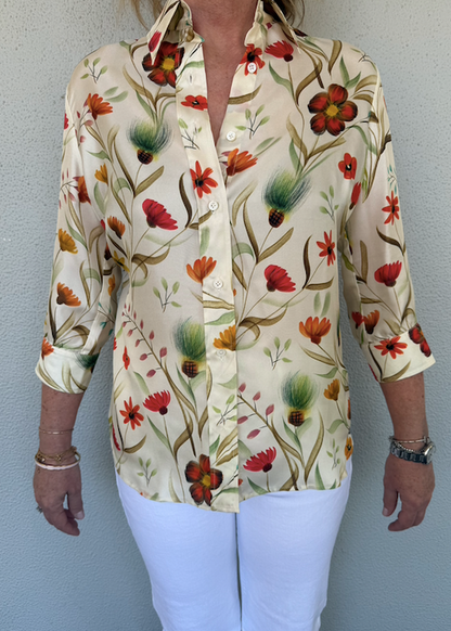 Woman wearing a floral blouse with a plain background