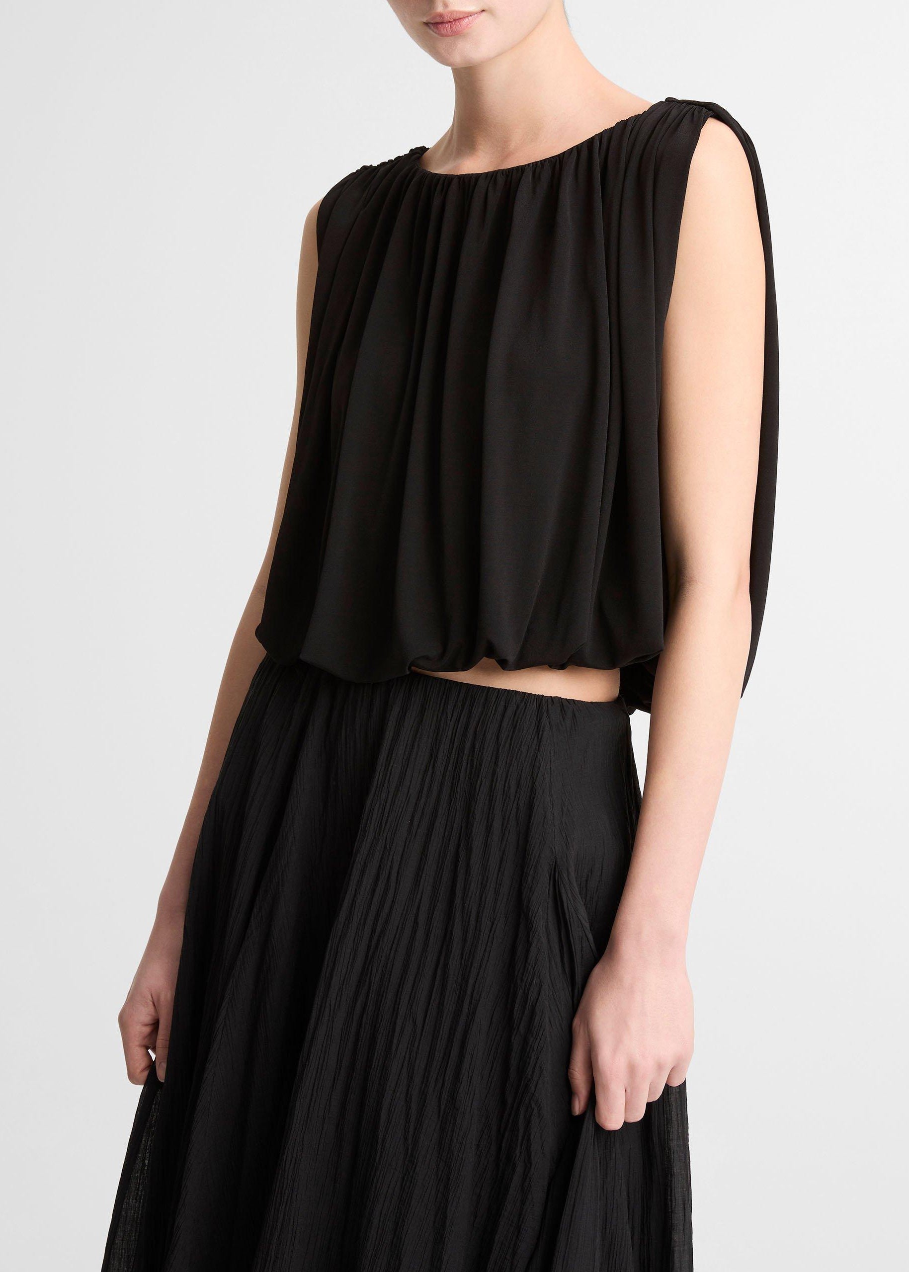 Black sleeveless top and skirt set on a plain background