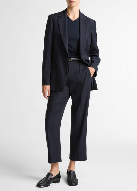 Person wearing a black suit on a white background