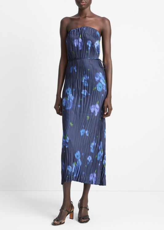 Woman wearing a strapless floral dress on a white background