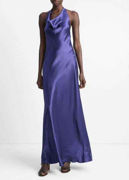 Woman wearing a long purple dress on a white background