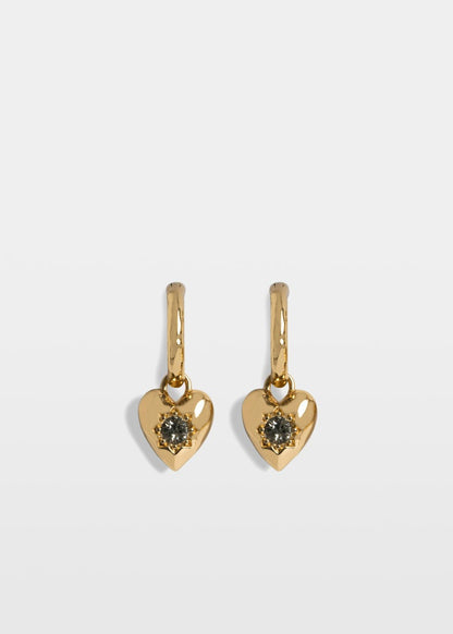 Gold heart-shaped earrings with gemstones on a light gray background