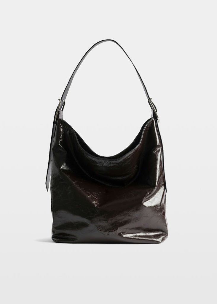 Black shiny handbag on a light gray background