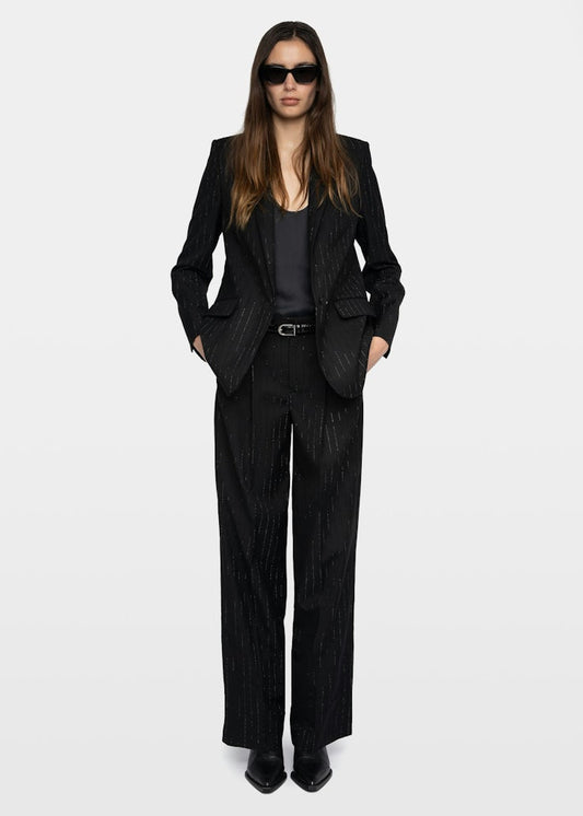 Person wearing a black suit and sunglasses on a white background