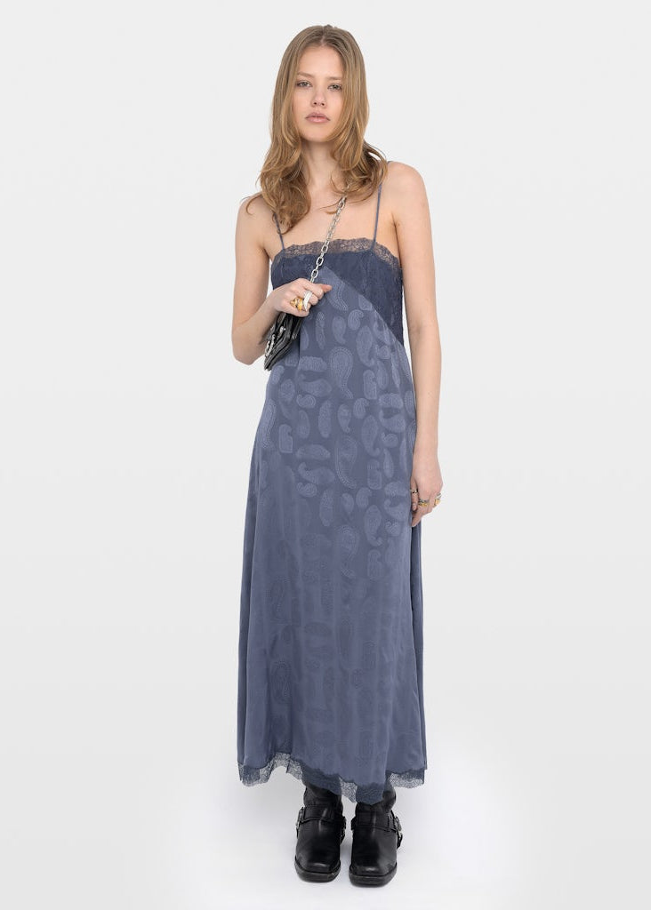Woman wearing a blue patterned dress on a white background