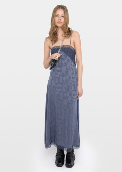Woman wearing a blue patterned dress on a white background