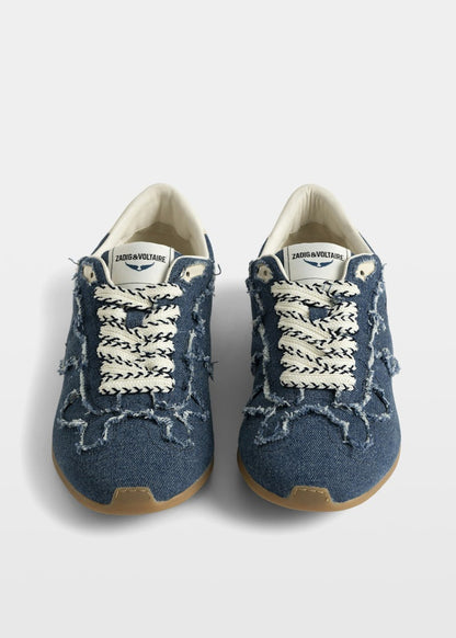 Pair of blue sneakers with white laces on a white background