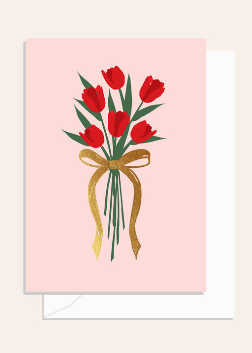 Greeting card with red tulips and a gold bow on a pink background