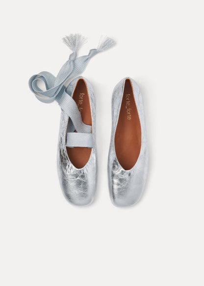 Silver ballet flats with a ribbon on a white background