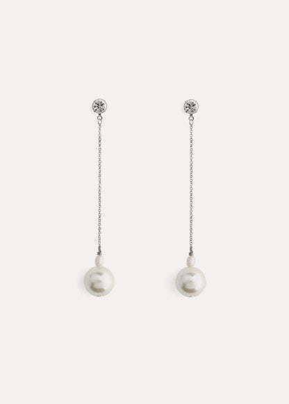 Pair of pearl earrings with chain on a white background