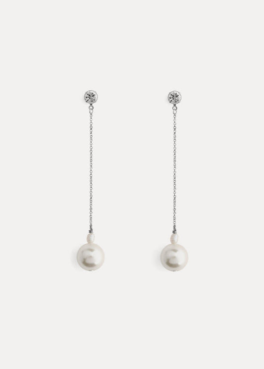 Pair of pearl earrings with chain on a white background