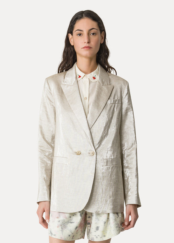 Woman wearing a light-colored blazer and skirt set on a white background