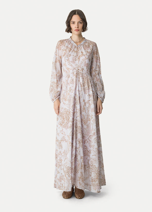 Woman wearing a long floral dress on a white background