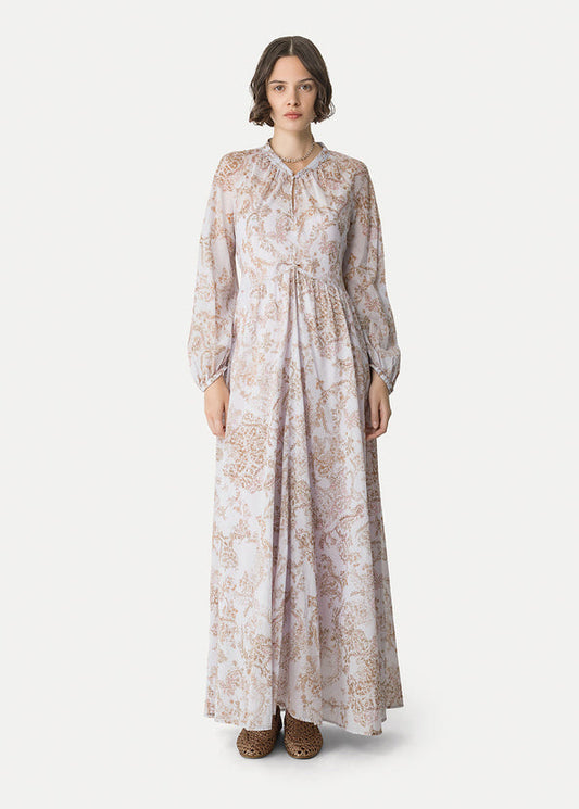 Woman wearing a long floral dress on a white background