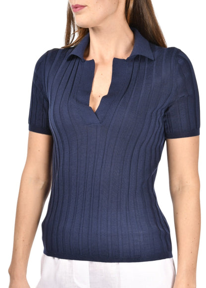 Woman wearing a navy blue ribbed short-sleeve blouse against a white background