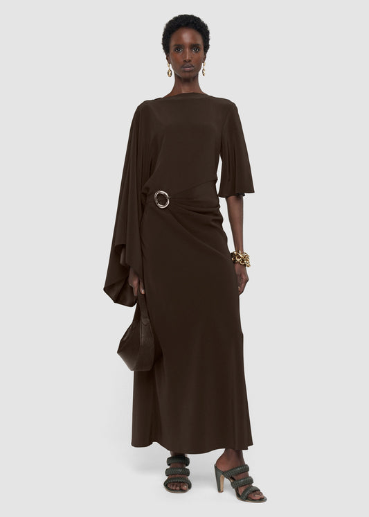 Woman wearing a brown dress with a belt on a white background