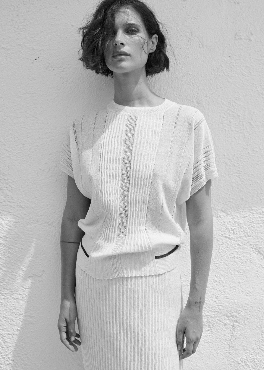 Black and white split-image of a woman wearing a white outfit against a light background.