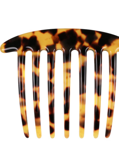 Tortoiseshell-patterned hair comb on a white background