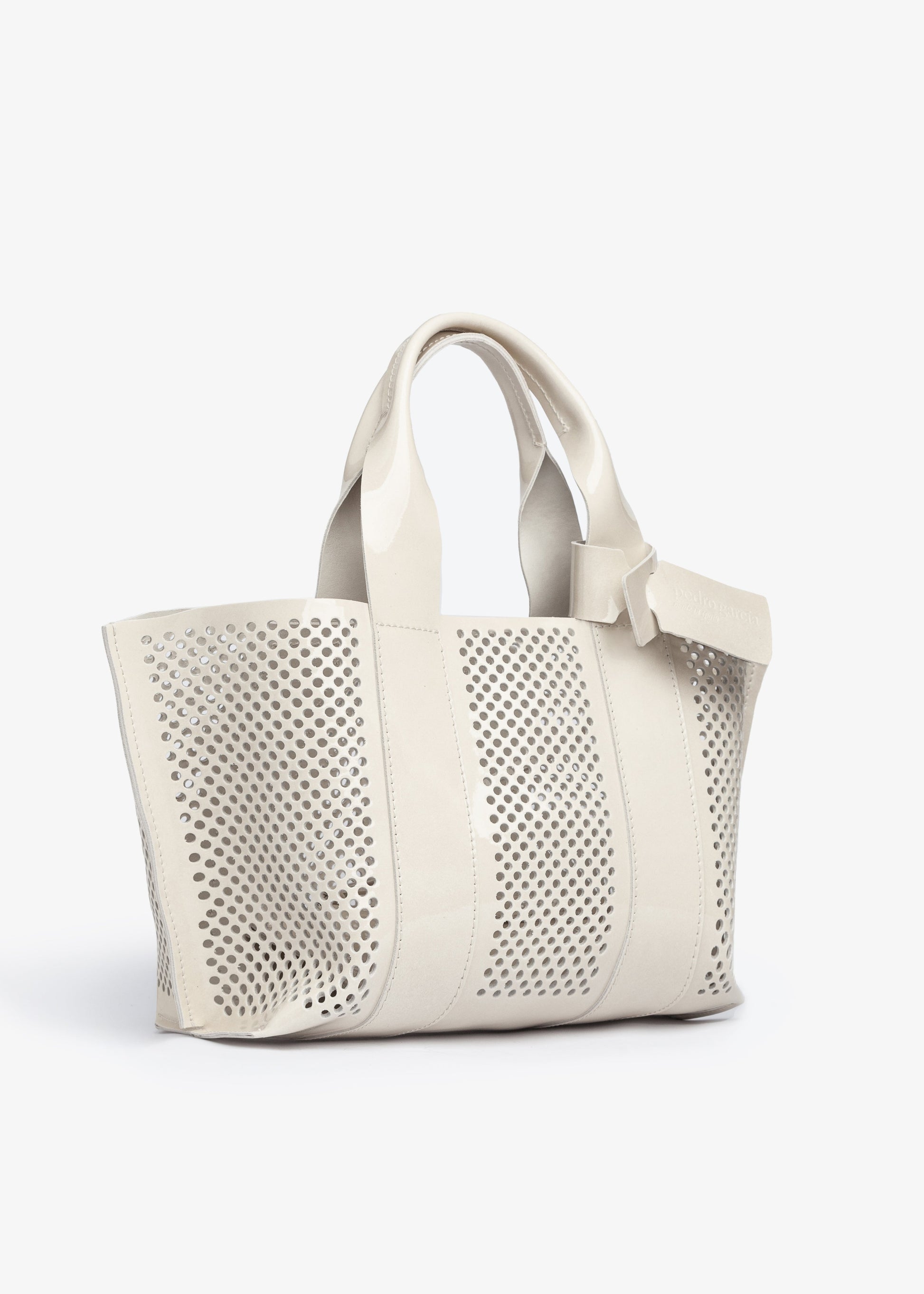 White perforated handbag on a white background