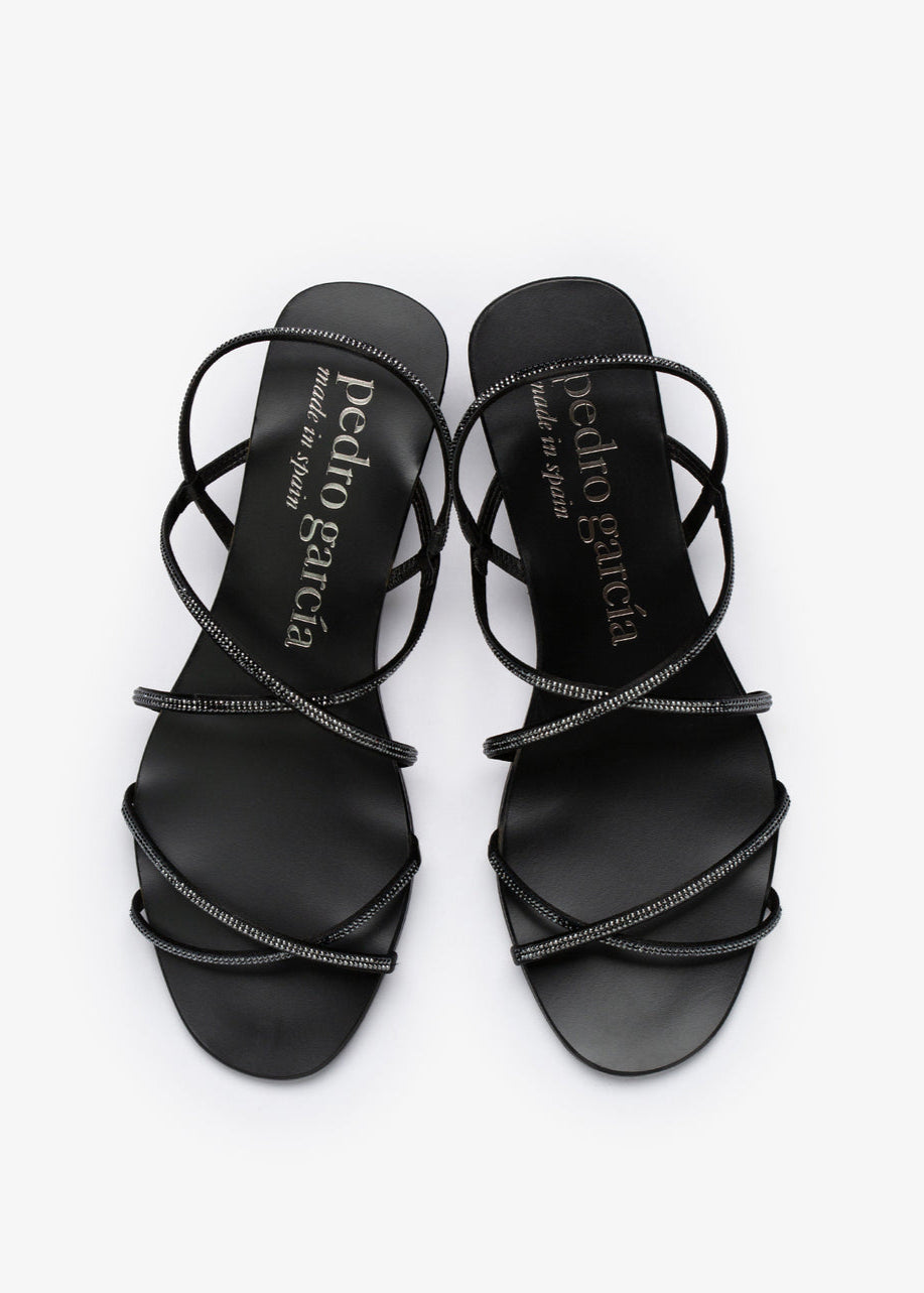 Black strappy sandals with 'Pedro Garcia' branding on a white background