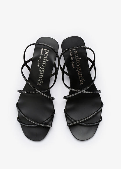 Black strappy sandals with 'Pedro Garcia' branding on a white background