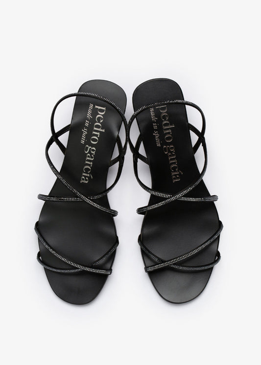 Black strappy sandals with 'Pedro Garcia' branding on a white background